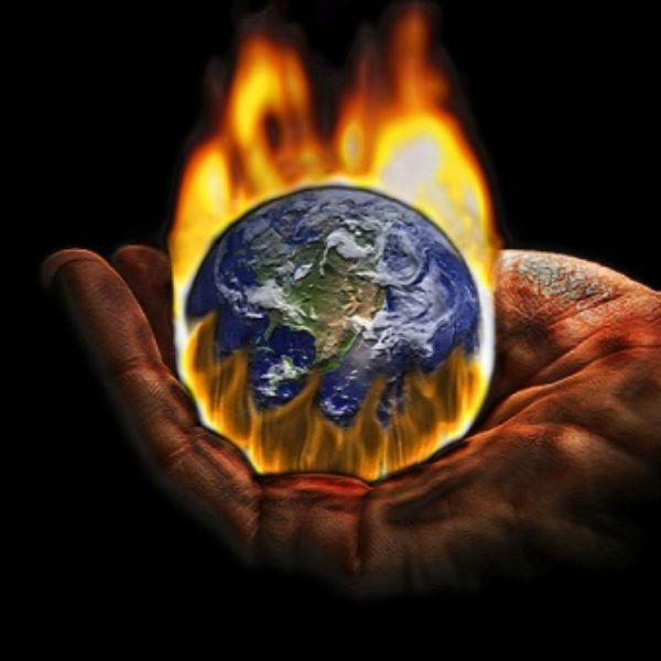 The earth’s burning fate lying within the palm of a hand, symbolizing the destruction of human  intervention with our environment.