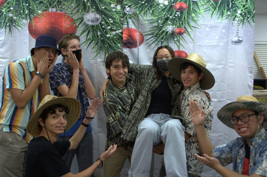 Students shout, Mele Kalikimaka (Merry Christmas) while posing for a Hawaiian themed family photo.