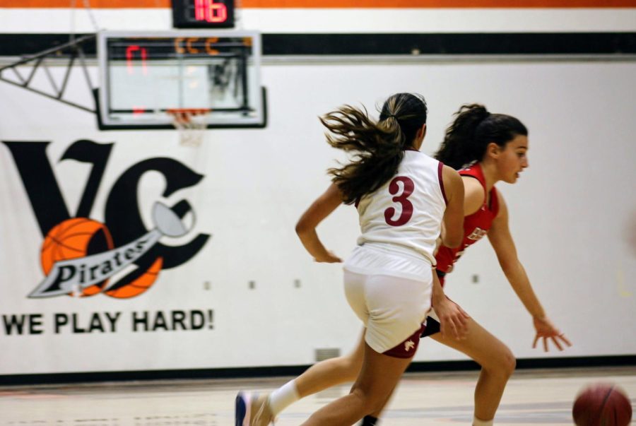 Playing intense man-to-man defense, Esmi Casarez '23 runs alongside her opponent in hopes to steal the ball for a fast break. 