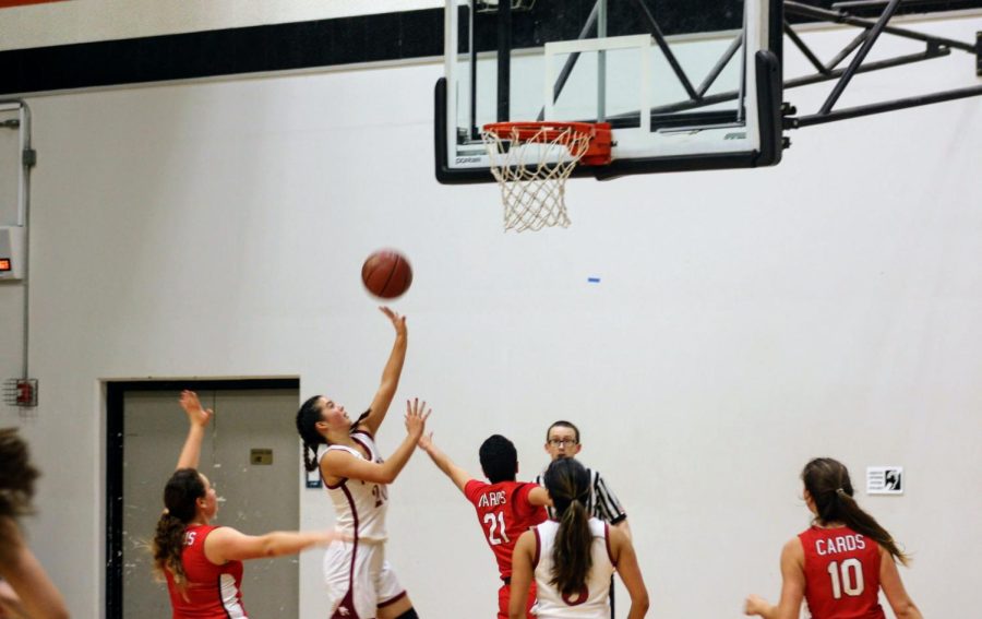 Olivia Huynh 23 leaps into the air attempting to score a layup. 