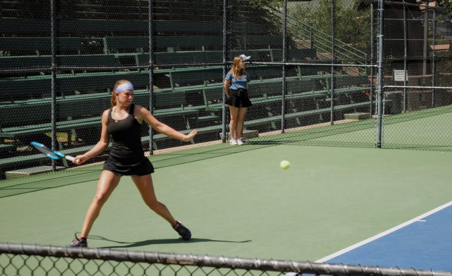 Nina Mitrofanova, representative of Southwestern University, lunges to hit a forehand, one shot that helped her win her division.
