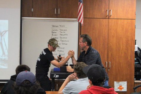 Aiden Hagerty 22 displays arm wrestling techniques against math teacher Wayne Powers.