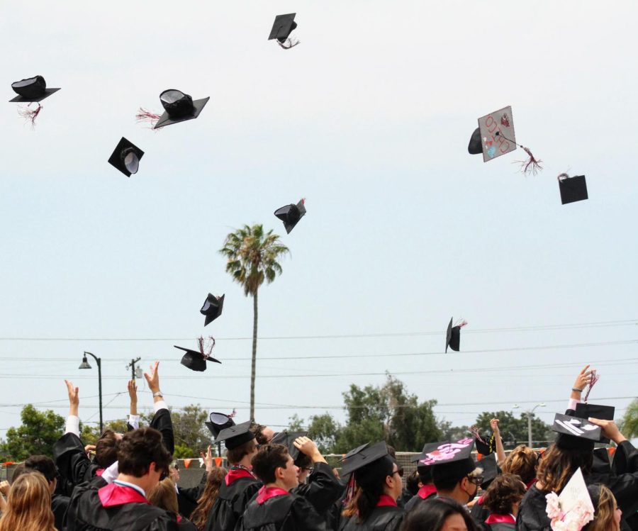 After receiving their diplomas, the graduating class move their tassels and throw their caps into the air to celebrate the end of their high school careers.