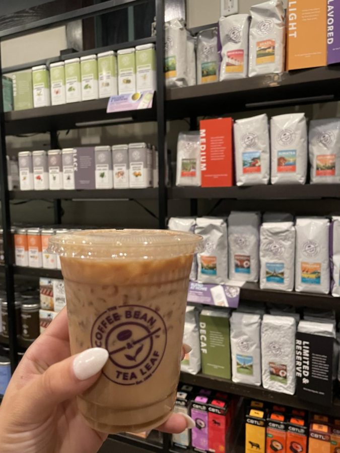 The dirty chai from Coffee Bean placed with a plethora of prepackaged coffee for home enjoyment.