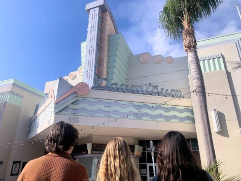 Foothill Technology High School students Anna English 24, Miles Baker 23 and Katelyn Neasham 24 gazing at the showtimes at Century Theaters in downtown Ventura.
