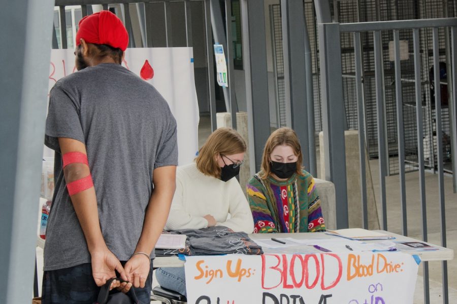 Laughing and chatting can be heard as students who have already finished donating blood, and students who are waiting to be called for their turn, gather and wait outside the Vitalant vans. 