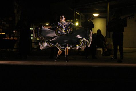A Foothill Tech student dances as the mariachi band plays music behind her.