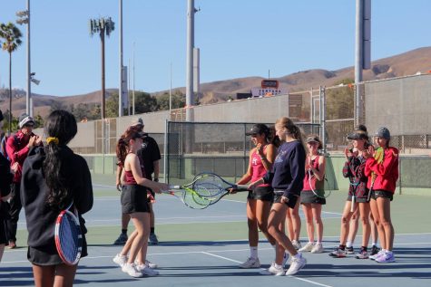 On the windy day of Nov. 2, 2022 girls’ tennis faced off against Simi Valley High School at Ventura College in their first round of CIF playoffs. Julia Geib ‘25 and Lola Tennison ‘24 are introduced to the players in their first match of the day, high-fiving them with tennis rackets and wishing them luck in the game to come. Players from both teams, wrapped in jackets to stay warm, show their support by clapping and cheering on their teammates.