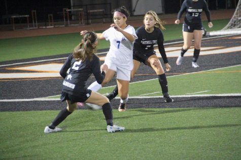 Maddie Wicks 26 (number 2) tries to stop her opponents efforts to send the ball upfield.