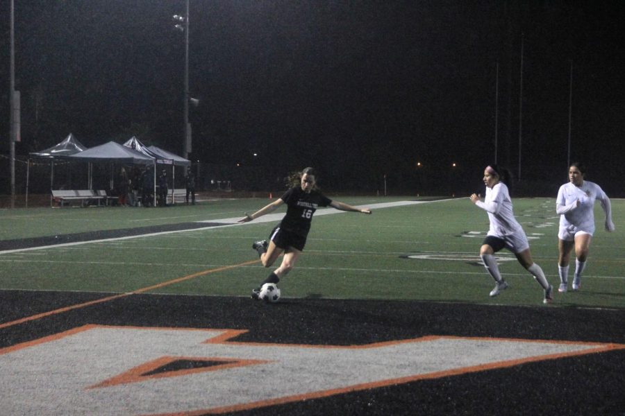 Claire Meehan 23 (number 16) winds up to kick the ball and score a goal to tie the game.