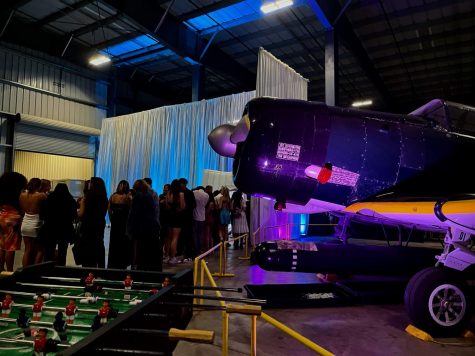 Small planes provide engaging decorations for the students lining up to get photos from the light up booth. Video games and foosball are also stationed away from the dance floor to allow friends to mingle in an open space.