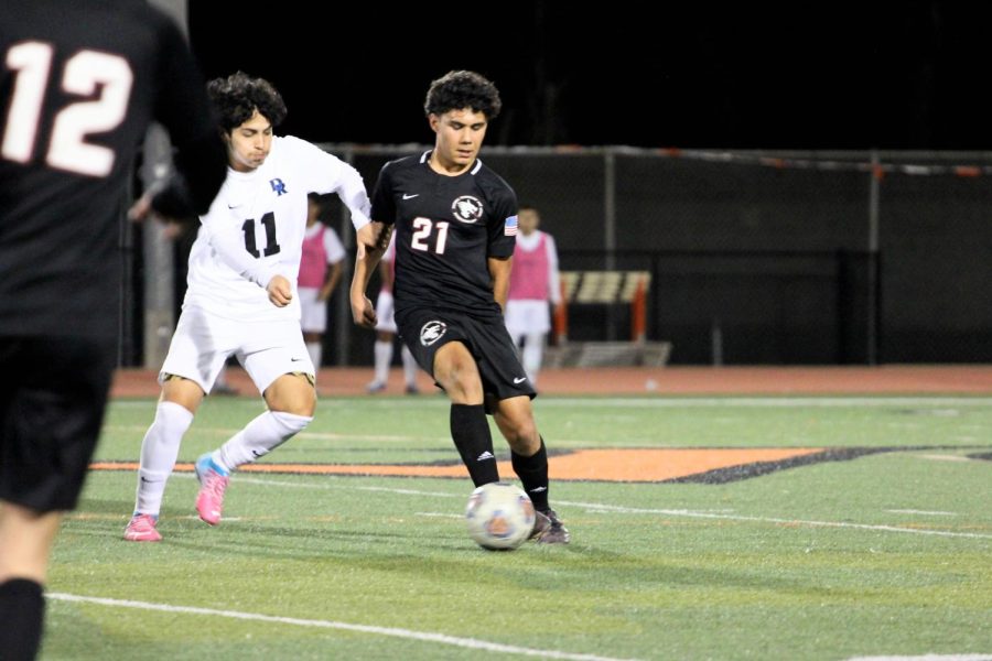 Diego Vega 24 (number 21) uses his agility to blow by his opponent and spots his open teammate Nicholas Flores 24 (number 12) who pushes the ball to their rivals territory.