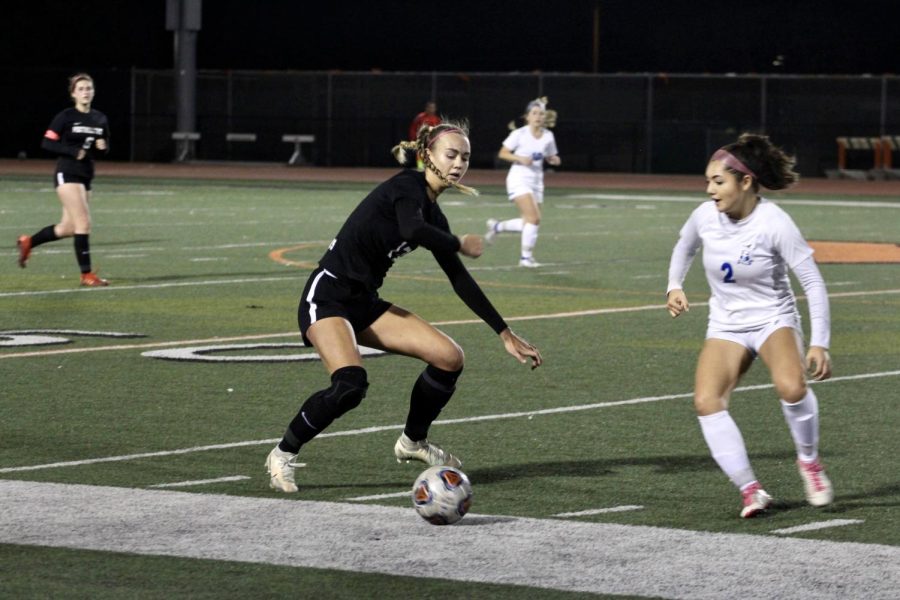 On the night of of Feb. 8, 2023, the girls soccer team faced off against Filmore High School for the first round of CIF games. Lily Shadden 23 (number 17) fights to keep the soccer ball in bounds while her defender closes in. After receiving the pass, Shadden dribbles the ball down the field making a crucial offensive play, hoping to score a goal for the Dragons in the first half.