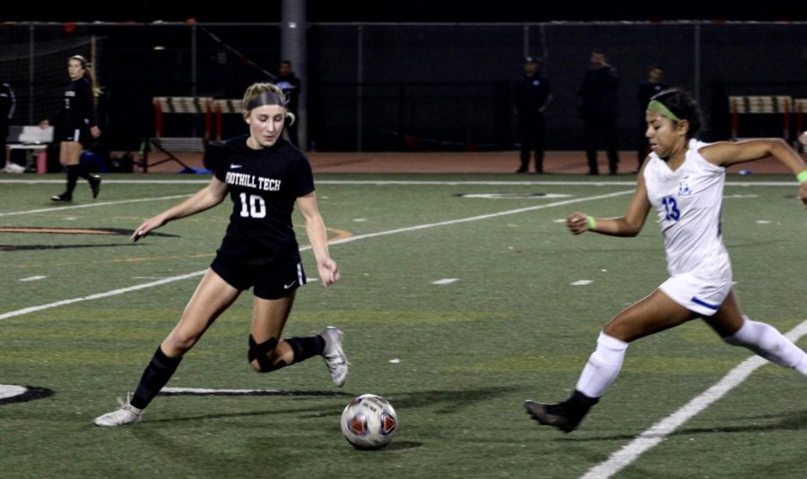 Tyler Hickerson 26 (number 10) rushes to the ball, beating her defender and getting ready to pass it to a teammate. Throughout the game, Hickerson was a vital offensive player, especially in the second half when she scored the first goal for the Dragons.