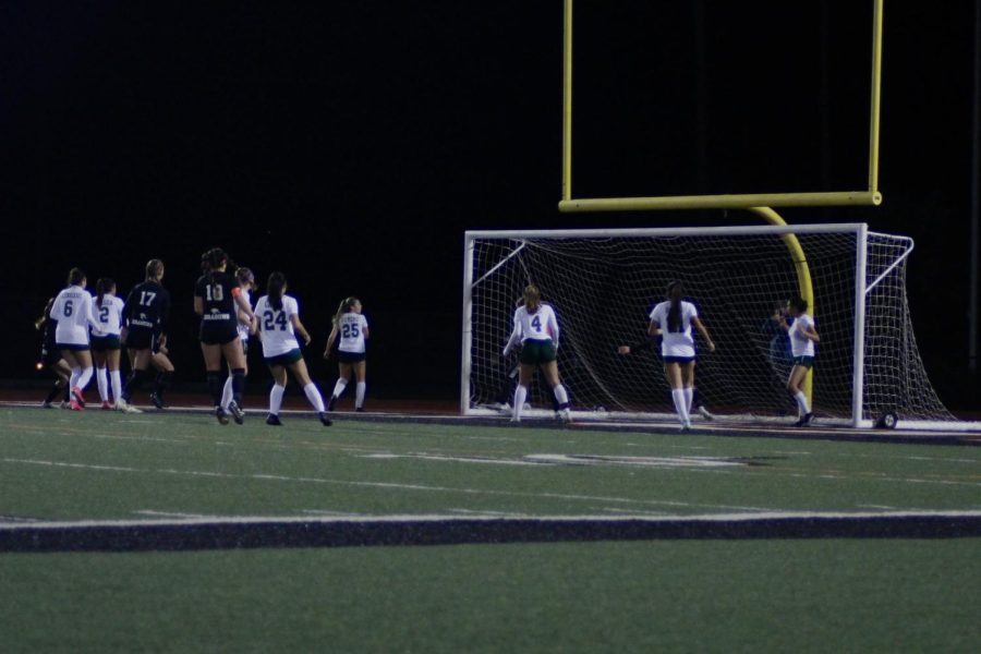 On the night of Jan. 31, 2023, girls' soccer gathered together to play their cross-town rival, St. Bonaventure High School. In the photo, the Dragons watch anxiously as the ball soars through the air, hoping that it will fly past the goalie and straight into the goal.