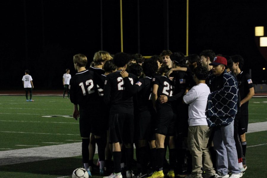 After+their+senior+night+ceremony%2C+the+boys+varsity+soccer+team+huddles+up.+Following+all+the+emotions+that+come+from+the+speeches+given+by+the+parents+of+the+seniors%2C+the+players+must+gather+together+to+focus+their+minds+on+the+game+they+are+about+to+play.