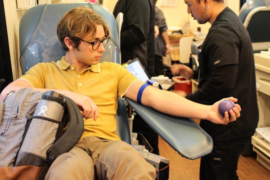 On+March+21%2C+2023%2C+Foothill+Tech+hosted+a+blood+drive+and+gave+students+the+opportunity+to+donate+blood+to+those+in+need.+Hayden+MacDougall+24+sits+in+a+Vitalant+trailer+and+compresses+a+ball+in+order+for+a+vein+to+appear.+MacDougalls+arm+was+also+binded+with+a+strap+to+put+pressure%2C+which+makes+it+easier+to+insert+the+needle.