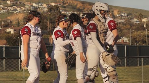Before the first pitch of each inning, the infielders of the softball team gather to exchange positive affirmations and high fives, keeping spirits high while playing defense. 