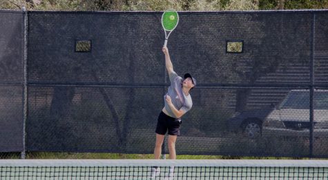 Ben Wang 23 rises up for a serve in his match for the Tri-Valley League title, which he ended up winning 6-4, 6-0.
