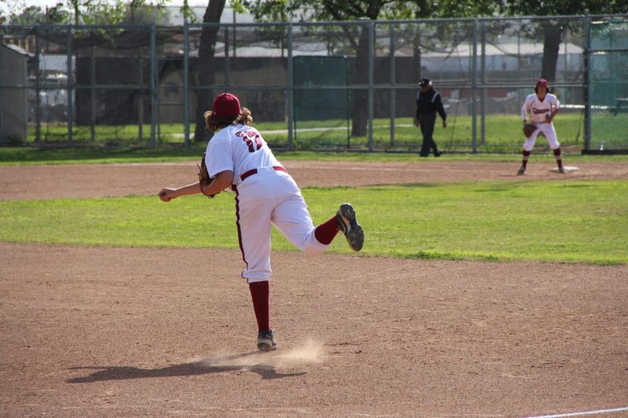 Bronson Taylor 24 aims at first base to hopefully get the runner before he touches the plate.