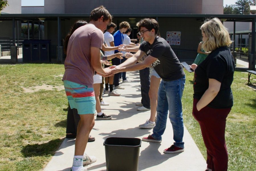 On May 12, 2023, fourth period AP Government and Economics participates in an outdoor activity to gain a better understanding of the relationships between workers, product and profit. As motivation to win, students race against the clock, hoping to beat the times of their peers in other class periods.