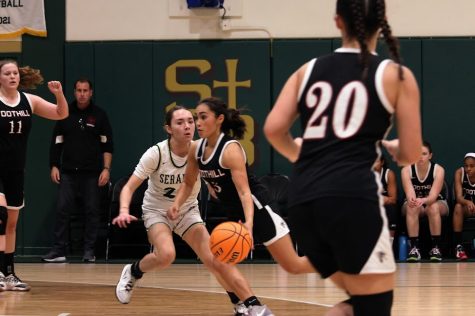 Esmi Casarez 23 drives toward the basket, getting in front of her defender, hoping to make a wide-open layup while her teammates watch in anticipation.