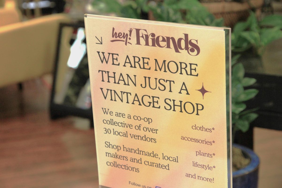 A sign displayed in the store highlights the unique vendors in the store as well as promoting shopping from local artists. 