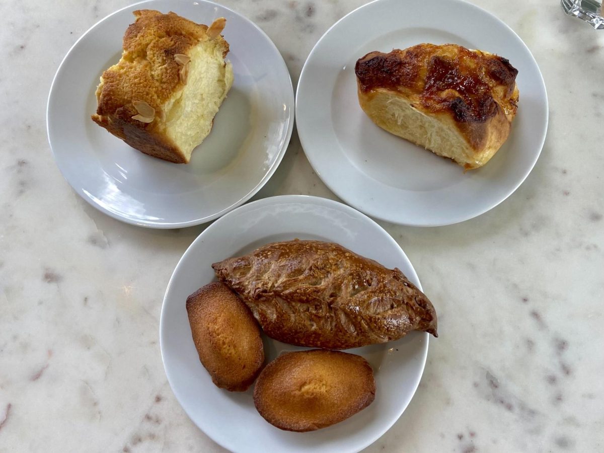 The sweet almond brioche (top right), tart plum brioche (top left), madeleines (bottom right) and mini sourdough baguette with walnuts (bottom left) all have a unique flavor, coming together to create a wonderful variety of pastries.