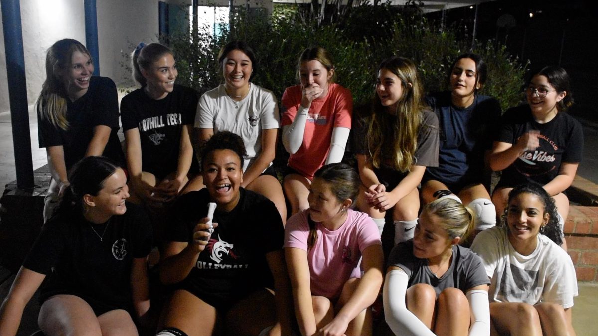 The varsity team laughs together as fun memories and conversations are shared, conveying their strong team connection.