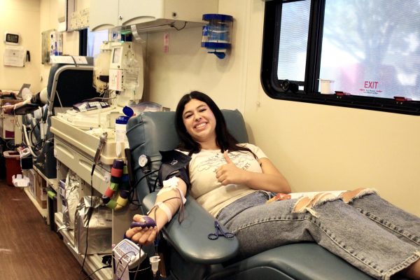 On Oct. 11, 2023, the BioScience Academy’s Health Occupations Students of America (HOSA) hosted a blood drive, teaming up with Vitalant, a non-profit organization serving those in need of blood. Alessia Saliby ‘24 sits with her legs propped up in one of Vitalant’s buses, squeezing a stress ball to help increase the flow of blood and making the withdrawal process quicker. Every single blood donation, like the one from Saliby, can save and improve the lives of up to three patients.
