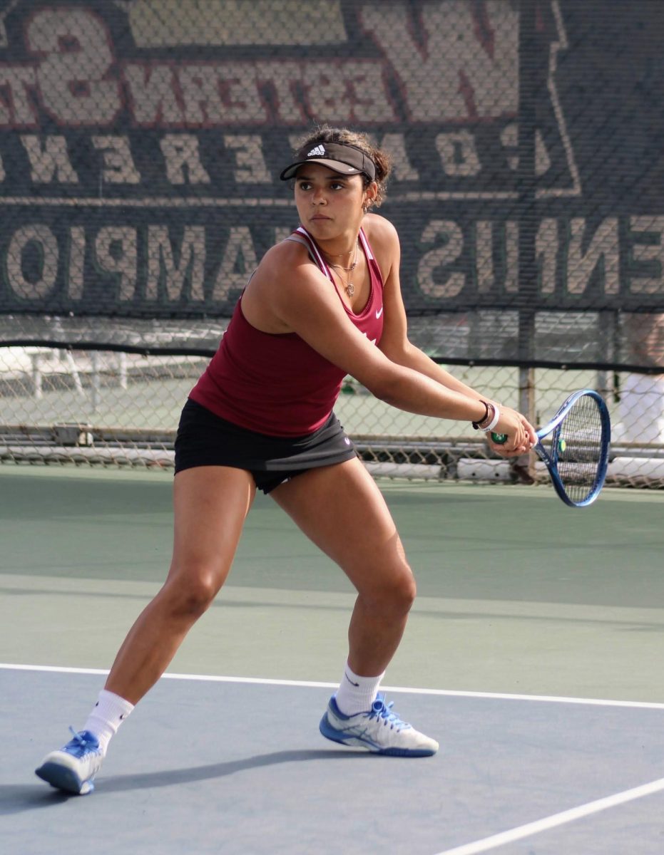 Lola Tennison 24 focuses on the ball as she prepares to send it back to her opponent.