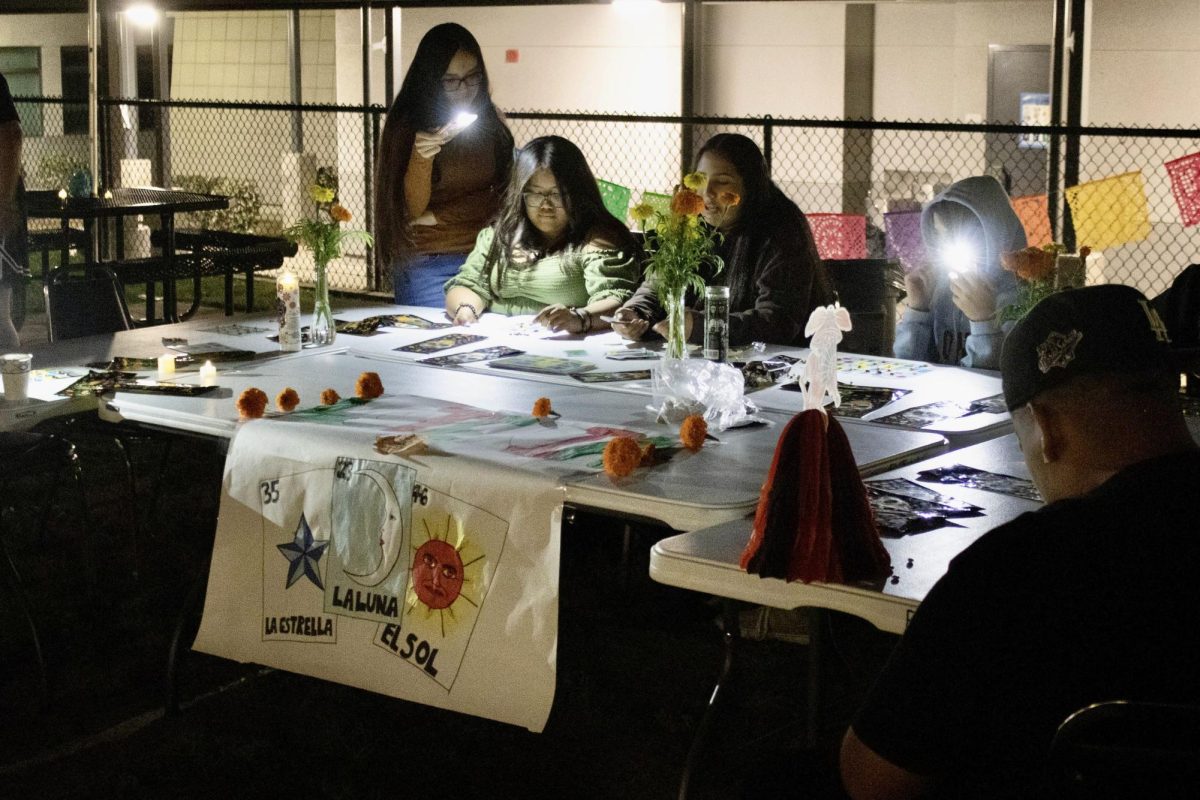 As it is a common tradition of Día de los Muertos, loteria boards were passed out to any participant who wanted to join in and play the game. Illuminated by flashlights to help see the boards better, everyone was able to connect over laughter and shared stories, while they worked to complete their loteria boards.