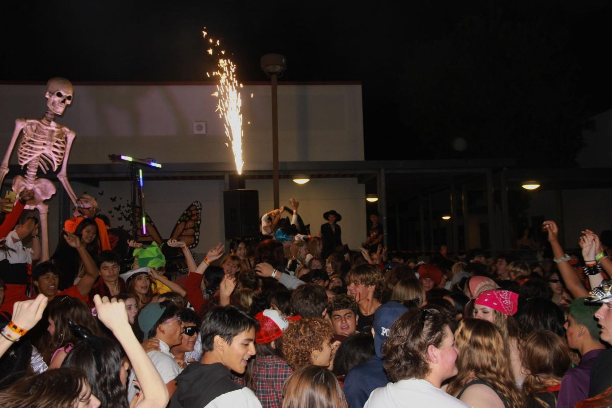 Foothill Technology High School (Foothill Tech) students hold up their hands during the song Party in the U.S.A. by Miley Cyrus at the A Nightmare on Day Road dance. The evening of Nov. 3, 2023 was filled with fun and excitement for every student in attendance.