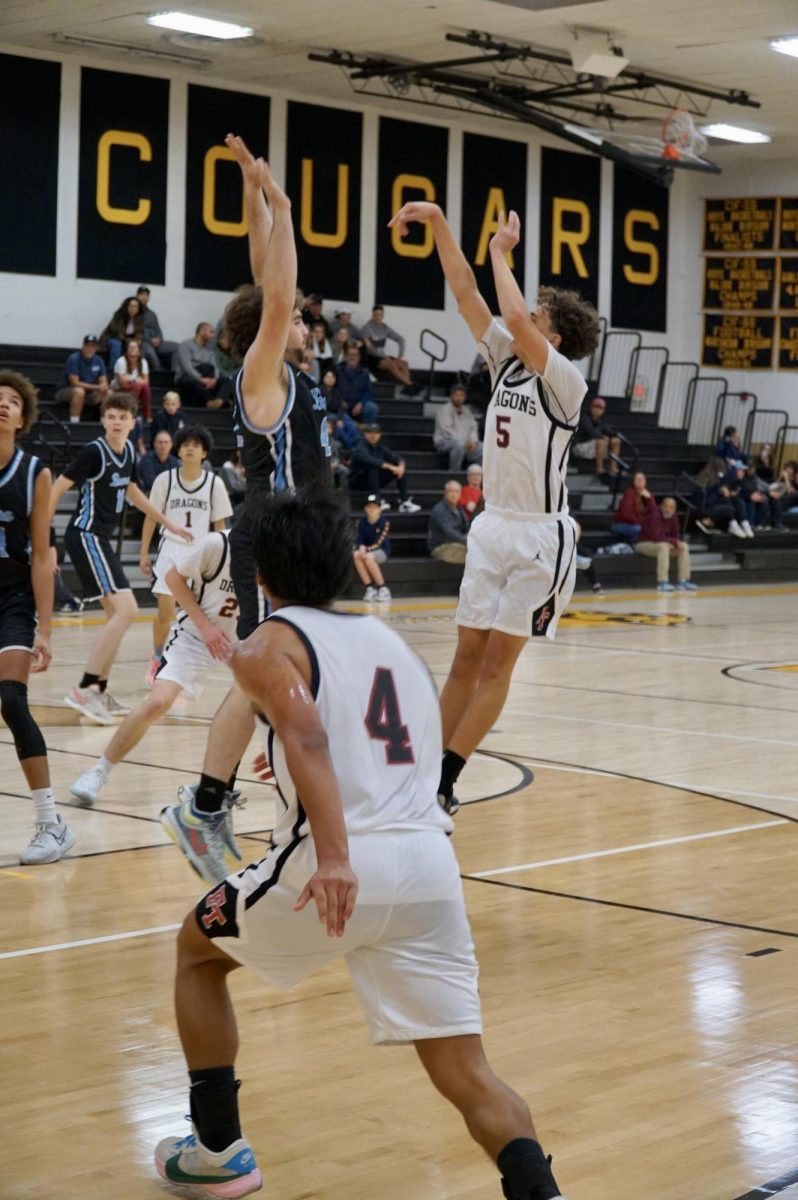 Looking to gain momentum in the second half, Nick Drucker 26 (number 5) pulls up for a well-contested jump shot, taking advantage of his defender’s momentary lack of attention.