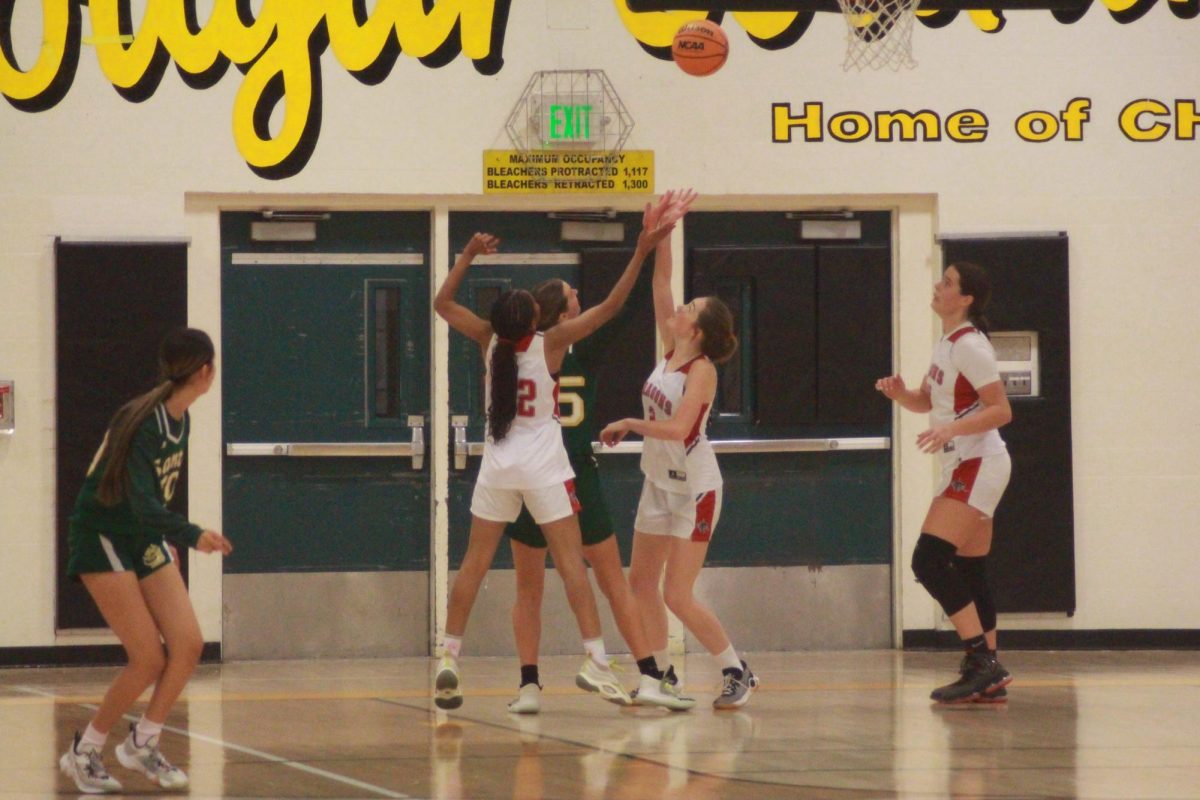 On Dec. 14, 2023, Foothill Technology High School (Foothill Tech) girls’ basketball faced a heartbreaking loss to Santa Barbara High School (Santa Barbara) with a score of 31-34. In this photo, Janae Dixon 24 (number 22) and Rihanna Samples 25 (number 2) jump up trying to secure the rebound for an offensive possession.
