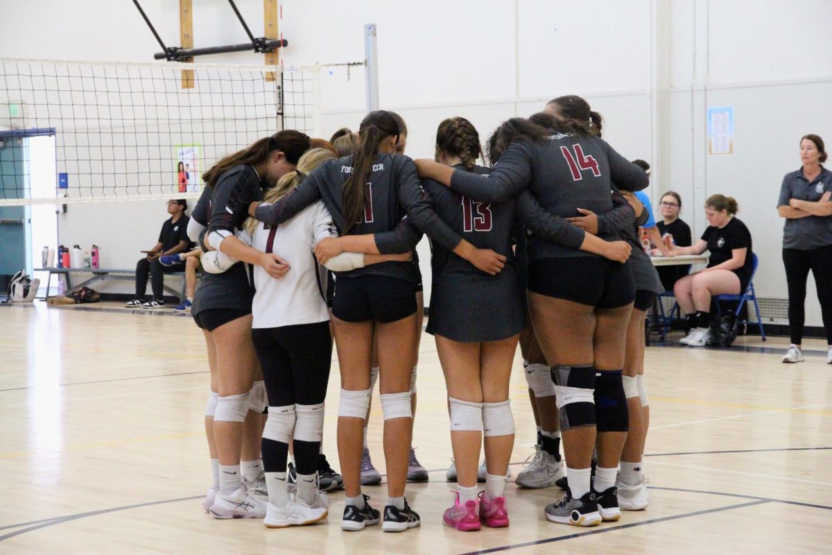 Foothill Technology High School's (Foothill Tech) varsity girls volleyball team gathers in a huddle moments before starting the game against Villanova Preparatory School (Villanova) on Sept. 10, 2024. Team Captains Morgan Houston '25 and Channing McClure '25 gather with teammates to encourage and strategize with their team.