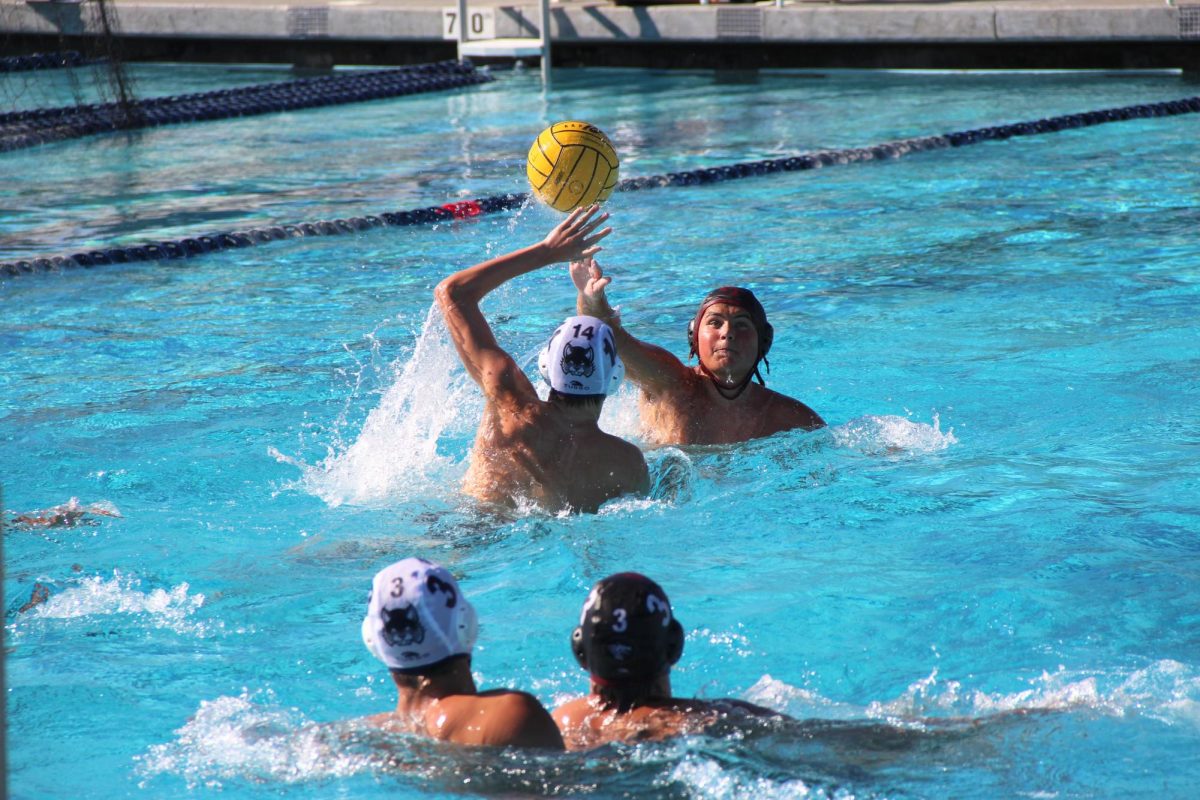 Dean Liddell ‘27 (number 9) strategically passing the ball to his teammate over the opposing team's defense. Liddell plays the left wing position and was a crucial tool in order for his team to secure the win. Even though only a sophomore, his talents and skills shine through the water and reflect on the scoreboard.