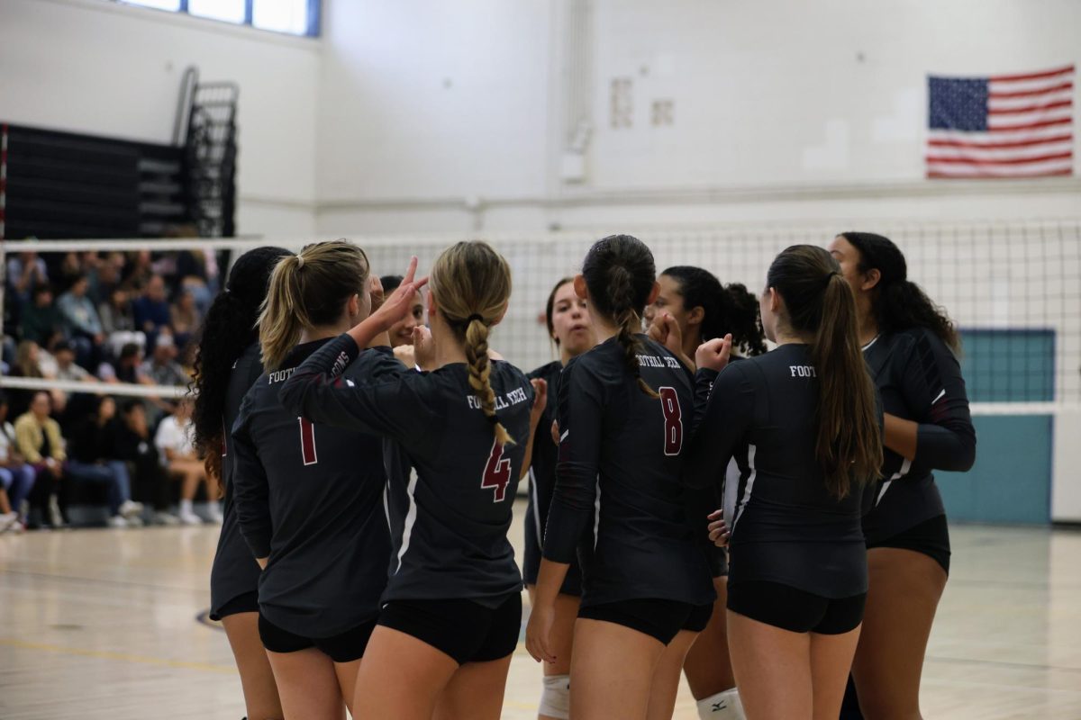 Foothill Technology High School's (Foothill Tech) varsity girls volleyball team huddles during a time out before winning the second match against Ventura County Christian School on Sept. 20, 2024. The players talk and continue to play with determination to secure the win.