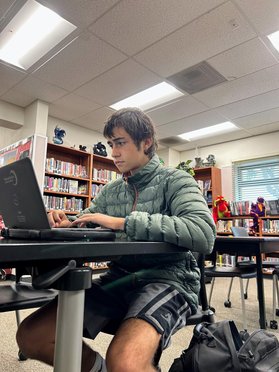 Henry Fulk '25 focuses on his computer in the Media Center during nutrition completing work for his classes. Some students at Foothill Technology High School (Foothill Tech) prefer to complete their work on paper and other prefer to complete it on the computer.