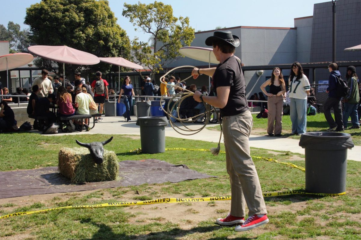 Jacob Hatler '27 throws a lasso, roping the bulls horns in honor of the vaquero: the original cowboys in America. As he's roping, he sports a vaquero hat, appreciating Hispanic culture.