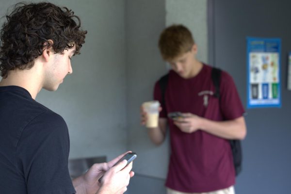 Colton Salles ‘27 and Sawyer Donaldson ‘27 are on their phones while standing by the closed E-pod bathrooms during class time. The access to the E-pod bathrooms is closed due to the lack of administration available to make sure that students going to the restrooms do not use devices.