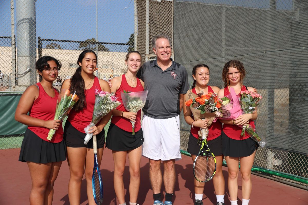 During the senior ceremony, Aditi Shanbhag ‘25, Rhea Gill '25, Julia Geib '25, Ryan Alderman '25 and Vivian Ryan '25 pose with their coach of four years, holding flowers given by their families to celebrate the match dedicated to them. Many of them, although teammates, are long time friends that have enjoy the sport of tennis together.