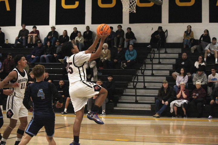 On Nov. 25, 2024, the Foothill Technology High School (Foothill Tech) boys basketball team played against Channel Islands High School (Channel Islands). Launching into the air with ball in hand, Enzo Rivera' 27 (number 35) looks to make a layup as half time approaches. Rivera's height and strength helped him make multiple layups thought the game.