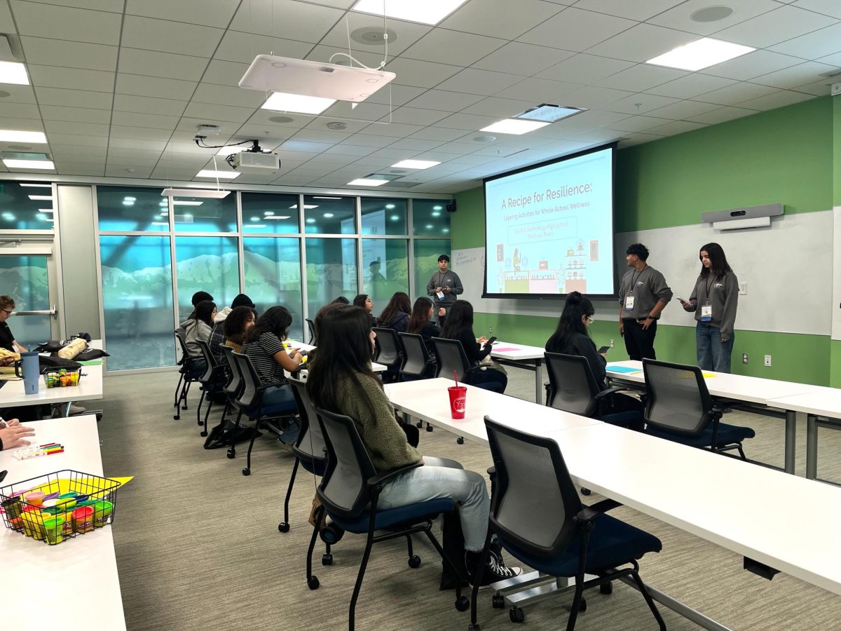 Jason Noufal '25, Angel Sanchez Moreno '26 and Loren Romero '25 proudly present their "Recipe for Resilience" slideshow. Using a cake analogy to show how they've been layering mental health activities this school year.