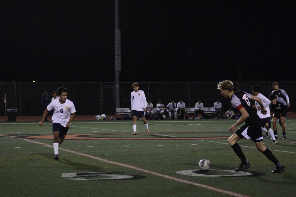 On the night of Nov. 25, 2024, Foothill Technology High School (Foothill Tech) varsity soccer players faced off against Santa Clara High School (Santa Clara). They took a clear lead from the beginning, and ended up securing a win 5-0. Conner Bursek '25 (number 19) can be seen putting pressure on Santa Clara's defense, and aiding the Dragons to mainitan their win. He looks for an opportunity to pass to his teammates further down on the field.