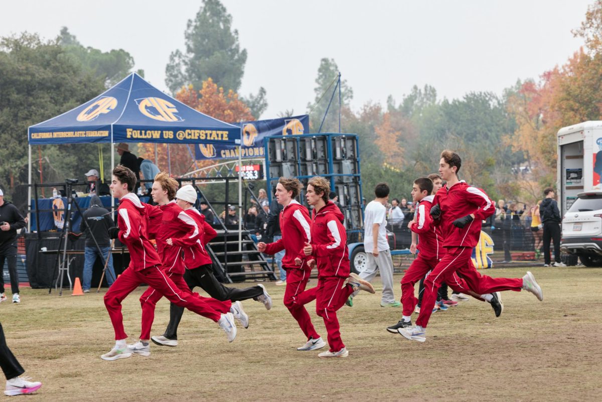 The Foothill Technology High School (Foothill Tech) boys cross country runners do strides out from the line to warm up for the race ahead, with emotions high they enjoy the scenic views Woodward Park has to offer. Chance Leandro '25 leads the pack out with the pressure of  the environment weighing heavy on moral.