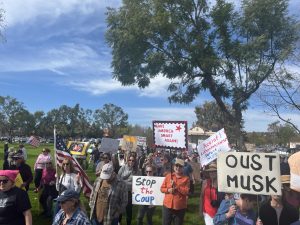 Directly after gathering at noon, and listening to a few rousing speeches, the protesters embarked from Constitution Park, and headed toward the Tesla Dealership. In unison, crossing the street and walking along the sidewalk, the group was determined to spread their message and peacefully protest their cause.