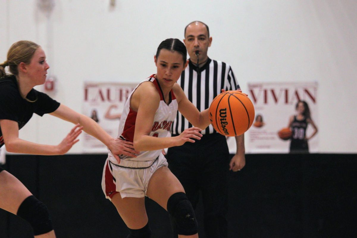 After securing second place in league with a 6-2 record, the Foothill Technology High School (Foothill Tech) girls basketball team embarked on their journey through California Interscholastic Federation (CIF) Southern Section Playoffs. With a 48-31 win over Pacifica Christian High School, the Dragons moved on to round two facing off against Tesoro High School (Tesoro) on Feb. 15, 2025. In this photo, Lauren Kaller '25 (number 0) drives past her defender toward the basket, determined to make a successful play on offense. Kaller put up 10 points and had many defensive stops and steals.