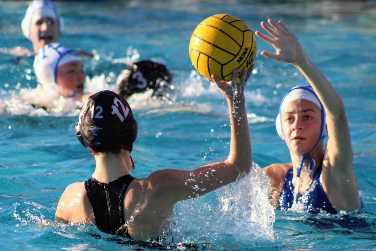 On Jan. 23, 2025 Foothill Technology High School (Foothill Tech) faced off against a league opponent Cate School (Cate) at the Ventura Aquatic Center. Lauren Happel '26 (number 12) scans the pool for an open teammate to give her team an advantage. Happel grips the ball tightly as her defender closes in and delivers a swift pass which later results in a score for Foothill Tech.