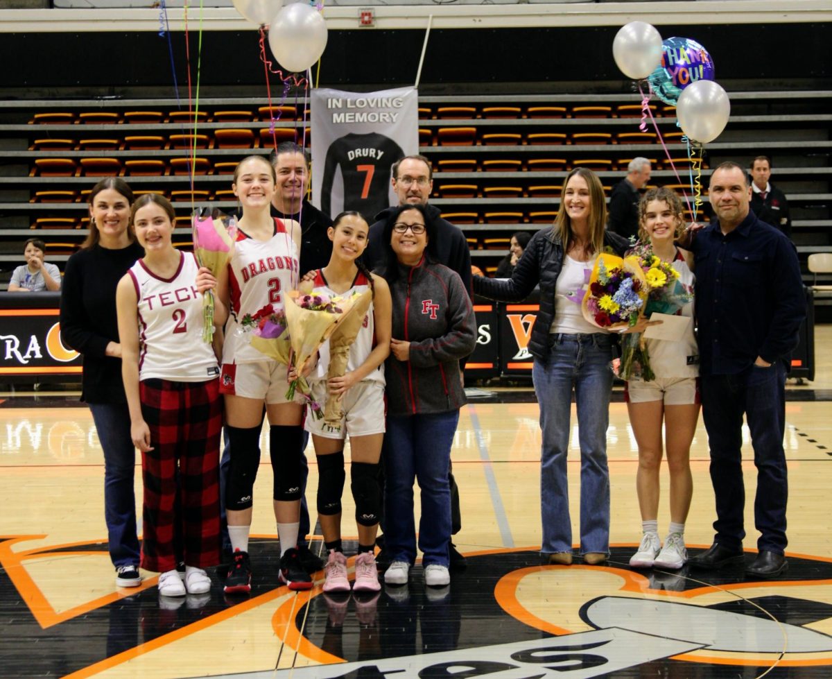 On the cold night of Jan. 24, 2025, Foothill Technology High School (Foothill Tech) girls basketball hosted their second and final game against Cate School (Cate) resulting in a 58-37 win. The game honored their graduating class of seniors, as their season winds down to an end. Each senior received flowers and heartfelt speeches from their teammates. Pictured is Rihanna Samples '25 (number 2), Lauren Kaller '25 (number 0) and Vivian Ryan '25 (number 30) posing with their families to celebrate their high school basketball careers.